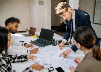 Group of professionals discussing blockchain technology and finance at a conference table.