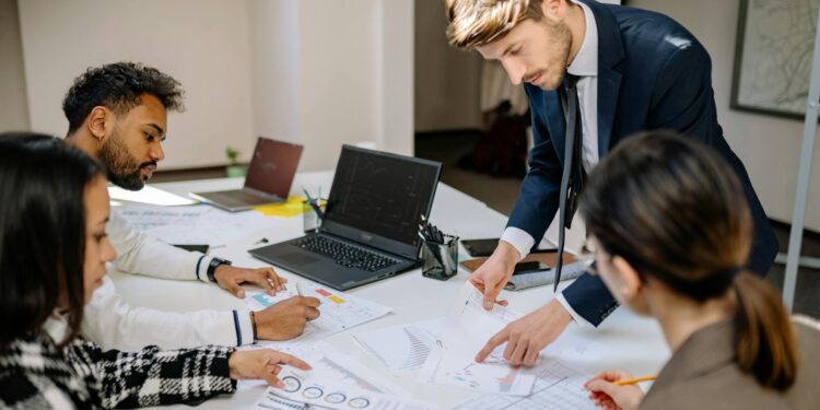 Group of professionals discussing blockchain technology and finance at a conference table.