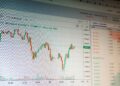 Bitcoin price chart showing upward movement amidst financial graphs and DeFi liquidity indicators.
