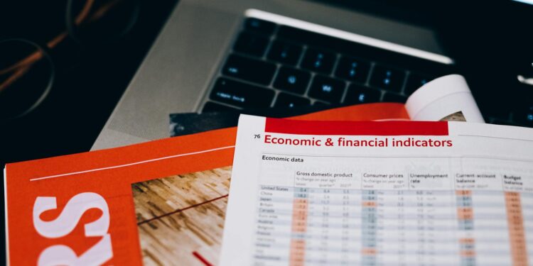 Business professionals discussing cryptocurrency regulations with financial documents on a table.