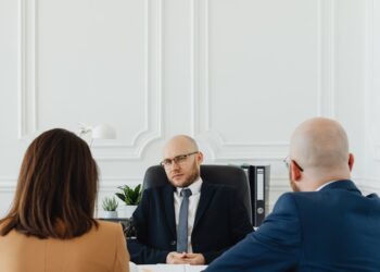 Binance CEO discussing legal options against sanctions related to Iran in a boardroom setting.