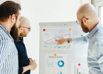 A group of finance influencers discussing investment strategies with charts and graphs displayed.