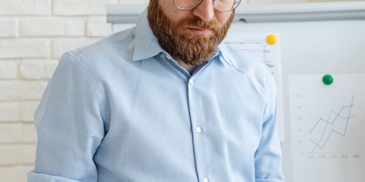 Sheikh Tahnoon at a financial conference with cryptocurrency graphics in the background.