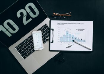 Two professionals discuss stablecoin integration with digital finance graphics in the background.