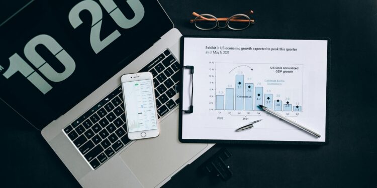 Two professionals discuss stablecoin integration with digital finance graphics in the background.