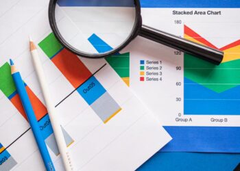 A financial regulator examines stablecoin market charts and compliance documents.