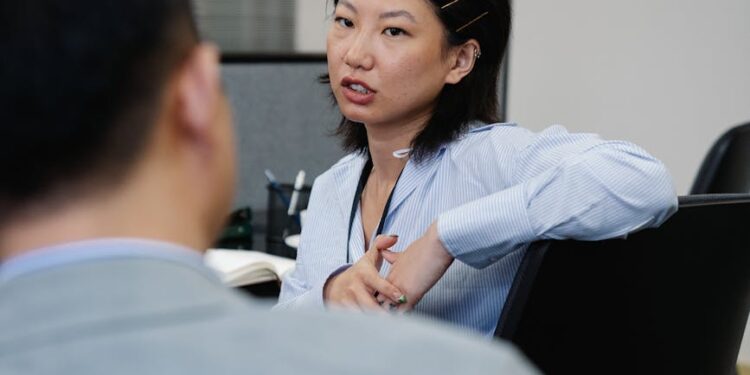 Employees in an office setting discuss strategies amid news of workforce cuts at Block Inc.