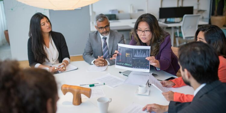 A diverse group of professionals discusses cryptocurrency data analytics.