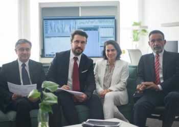 Business meeting with finance professionals discussing regulatory issues and insider trading.