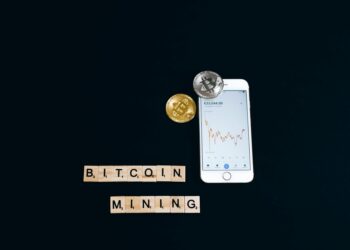 A digital representation of Bitcoin with fluctuating charts and global maps in the background.