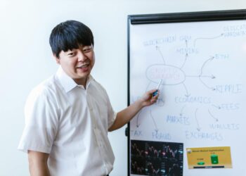 Two professionals discussing blockchain technology with digital finance graphics in the background.