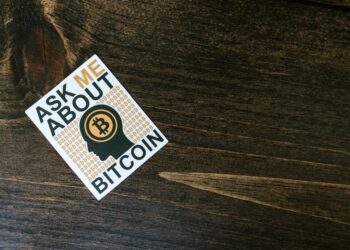 Bitcoin logo overlaid on financial charts with headlines about a major acquisition.