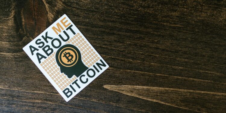 Bitcoin logo overlaid on financial charts with headlines about a major acquisition.