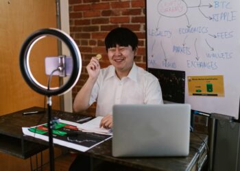 Members of Aave DAO discussing governance issues in a virtual meeting, cryptocurrency charts in background.