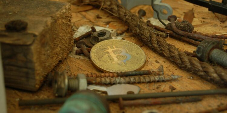 A digital representation of gold bars with cryptocurrency symbols, highlighting Tether's investment.