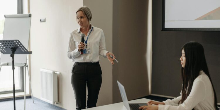Two military officials discuss AI technology in a conference room.