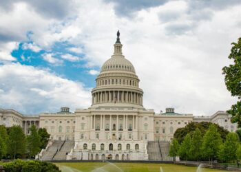 US Senator questioning Binance executives in a congressional hearing on sanctions compliance.