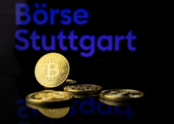 Vitalik Buterin speaking at a crypto conference, discussing portfolio diversification strategies.