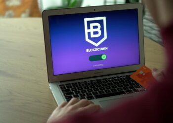 A computer screen displays cryptocurrency transactions and cybersecurity graphics.