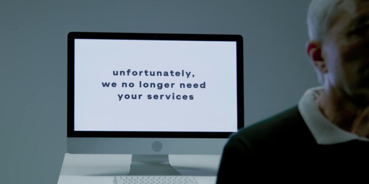 Employees at Block Inc. exit office building amidst layoffs announcement in financial sector.