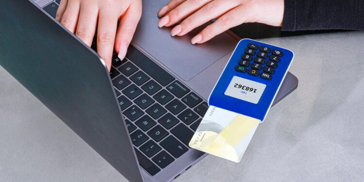 Bitcoin symbol overlaying a payment terminal with the Square logo, highlighting crypto transactions.