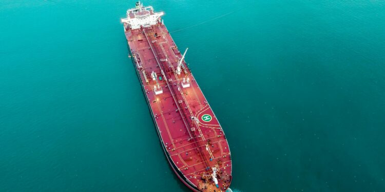 Oil tankers navigating the Strait of Hormuz, symbolizing Iran's yuan oil payment strategy.