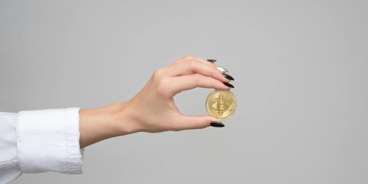 Government official examining cryptocurrency coins in a regulatory meeting.