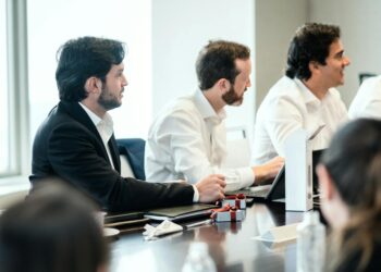 A concerned team discussing AI ethics and content guidelines in a modern office setting.