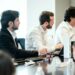 A concerned team discussing AI ethics and content guidelines in a modern office setting.