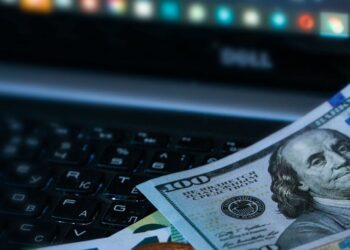 Bitcoin coin surrounded by financial charts, symbolizing stability amid rate cut uncertainty.