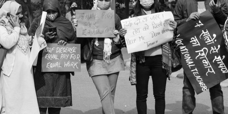 Crowd of protesters holding signs outside OpenAI offices, demanding a halt to AI development.