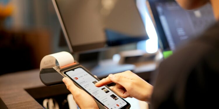 A smartphone displaying a Bitcoin payment screen in a retail setting.