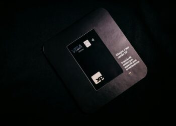 A Visa card with cryptocurrency symbols represents the launch of stablecoin cards globally.