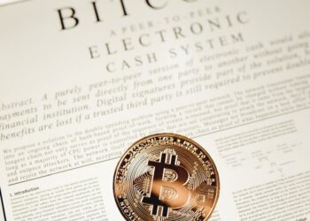 Indiana state Capitol building with a Bitcoin symbol and financial documents in focus.