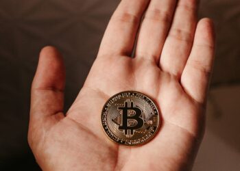 A digital representation of cryptocurrency coins alongside traditional financial symbols.