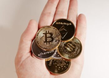 Hands holding a digital token representing blockchain-enabled Treasurys in a financial setting.
