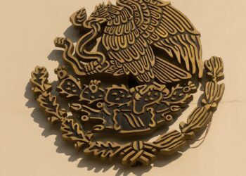 A KuCoin logo alongside the CFTC emblem, symbolizing their settlement.