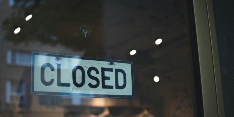 A closed storefront with a "Temporarily Closed" sign, reflecting Kalshi's halted operations.