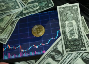 Bitcoin and oil price charts showing a surge, with upward trends and dollar signs.