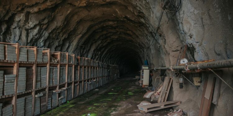 Bitcoin mining equipment in a dimly lit facility, illustrating operational challenges.