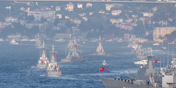 U.S. Navy ships maneuvering in the Strait of Hormuz amidst heightened tensions.