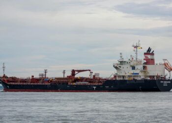 Oil tankers navigating the Strait of Hormuz amid a discussion on U.S. energy policy.