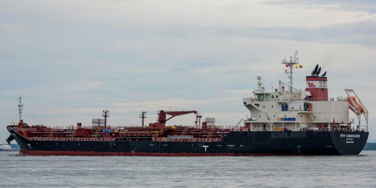 Oil tankers navigating the Strait of Hormuz amid a discussion on U.S. energy policy.