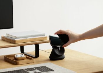 Bithumb office with cryptocurrency symbols and regulatory documents on the desk.