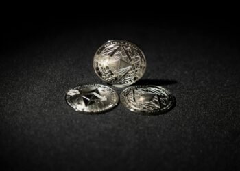 Ethereum coins stacked with a graph showing rising investment interest in cryptocurrencies.