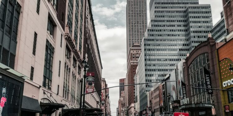 Modern office building in NYC with Ledger branding and a bustling urban backdrop.