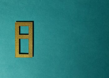 A digital illustration of a stablecoin symbol with gold bars in the background.