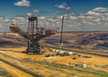 Bitcoin mining rigs in a large warehouse, emphasizing U.S. operations and regulations.