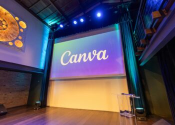 Crowd disperses at a Dubai conference venue, empty booths display cryptocurrency logos.