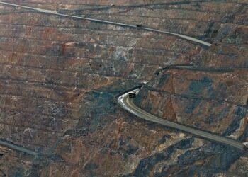 Aerial view of a large data center filled with rows of ASIC miners for Bitcoin mining.